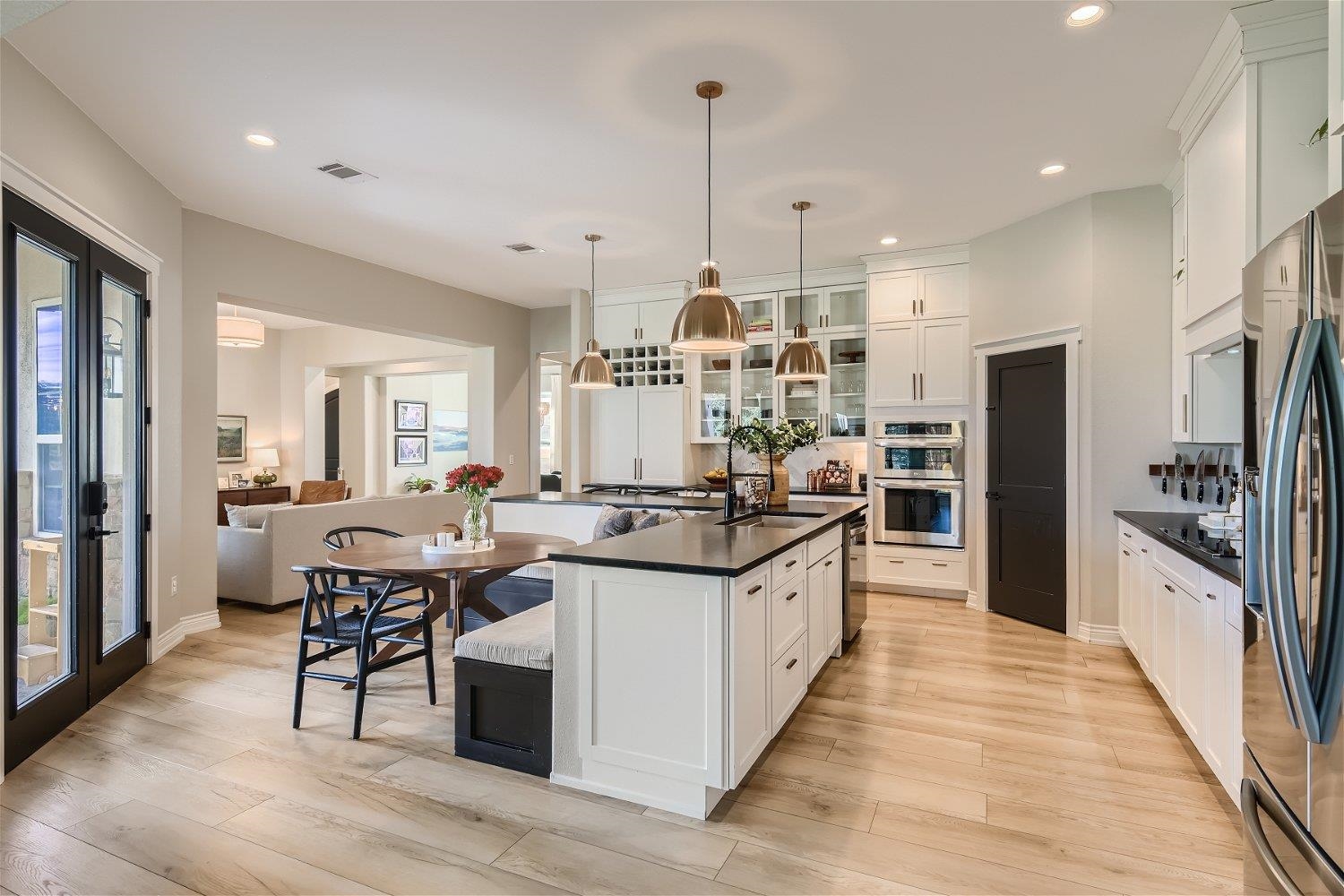 113 Vista View Trail Spicewood, TX 78669 - Photo 8 of 30 a kitchen with stainless steel appliances a kitchen island hardwood floor sink stove and wooden cabinets