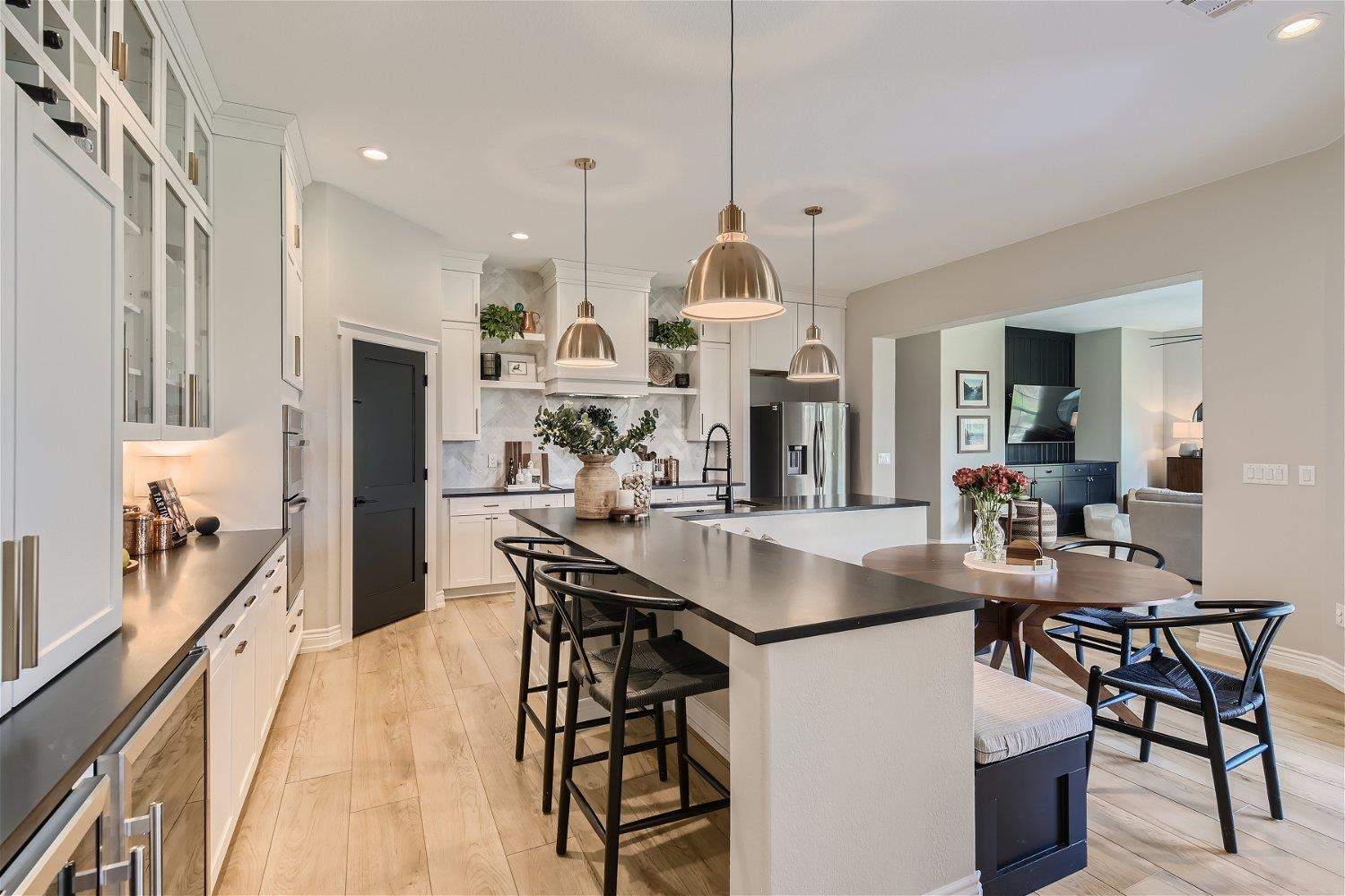 113 Vista View Trail Spicewood, TX 78669 - Photo 9 of 30 a view of a dining room and livingroom with furniture wooden floor a chandelier