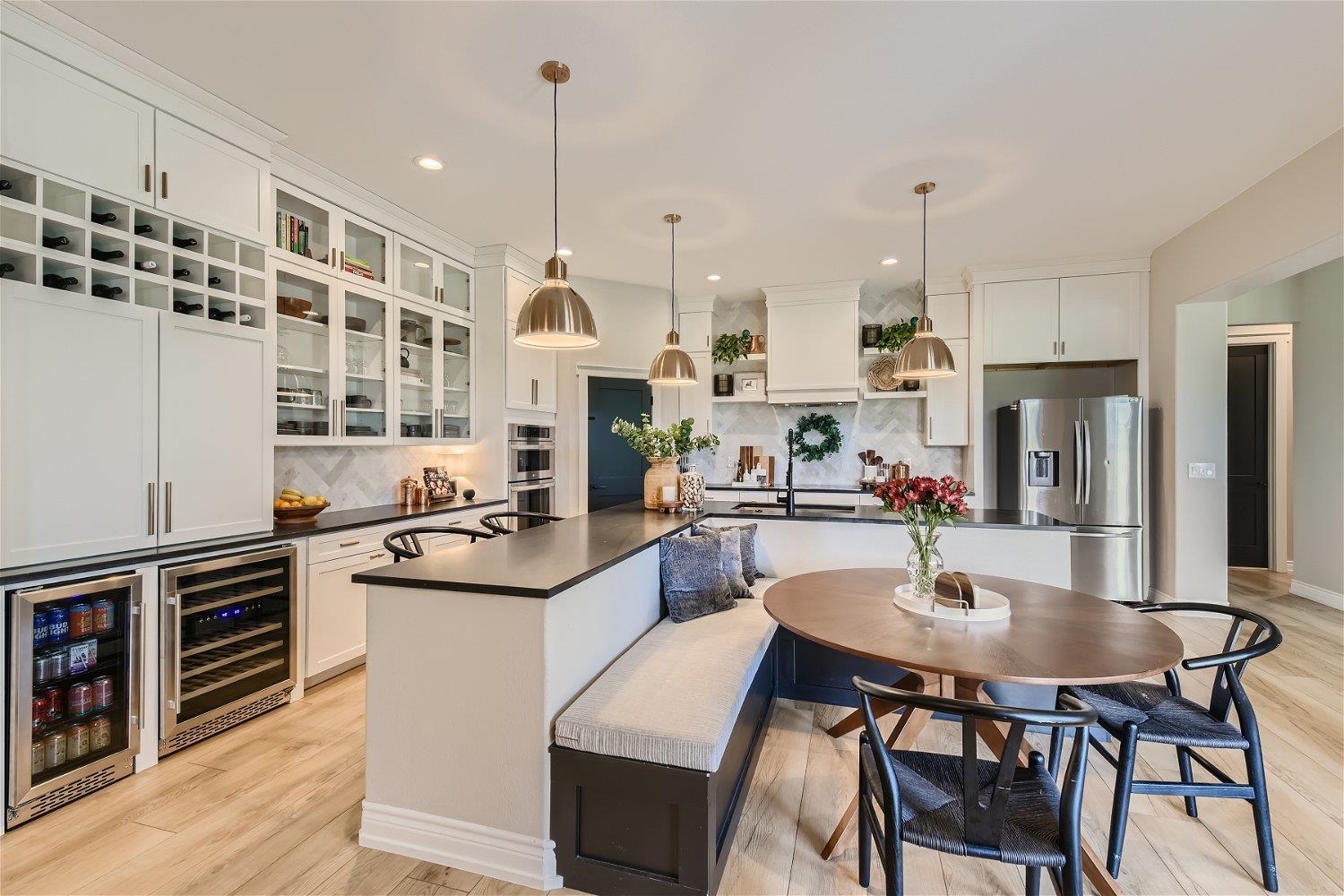 113 Vista View Trail Spicewood, TX 78669 - Photo 10 of 30 a kitchen with stainless steel appliances kitchen island granite countertop a sink a stove and chairs with wooden floor