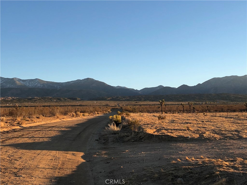 175 Cor Avenue Llano, CA 93544 - Photo 3 of 11 a view of a lake with mountain in the background