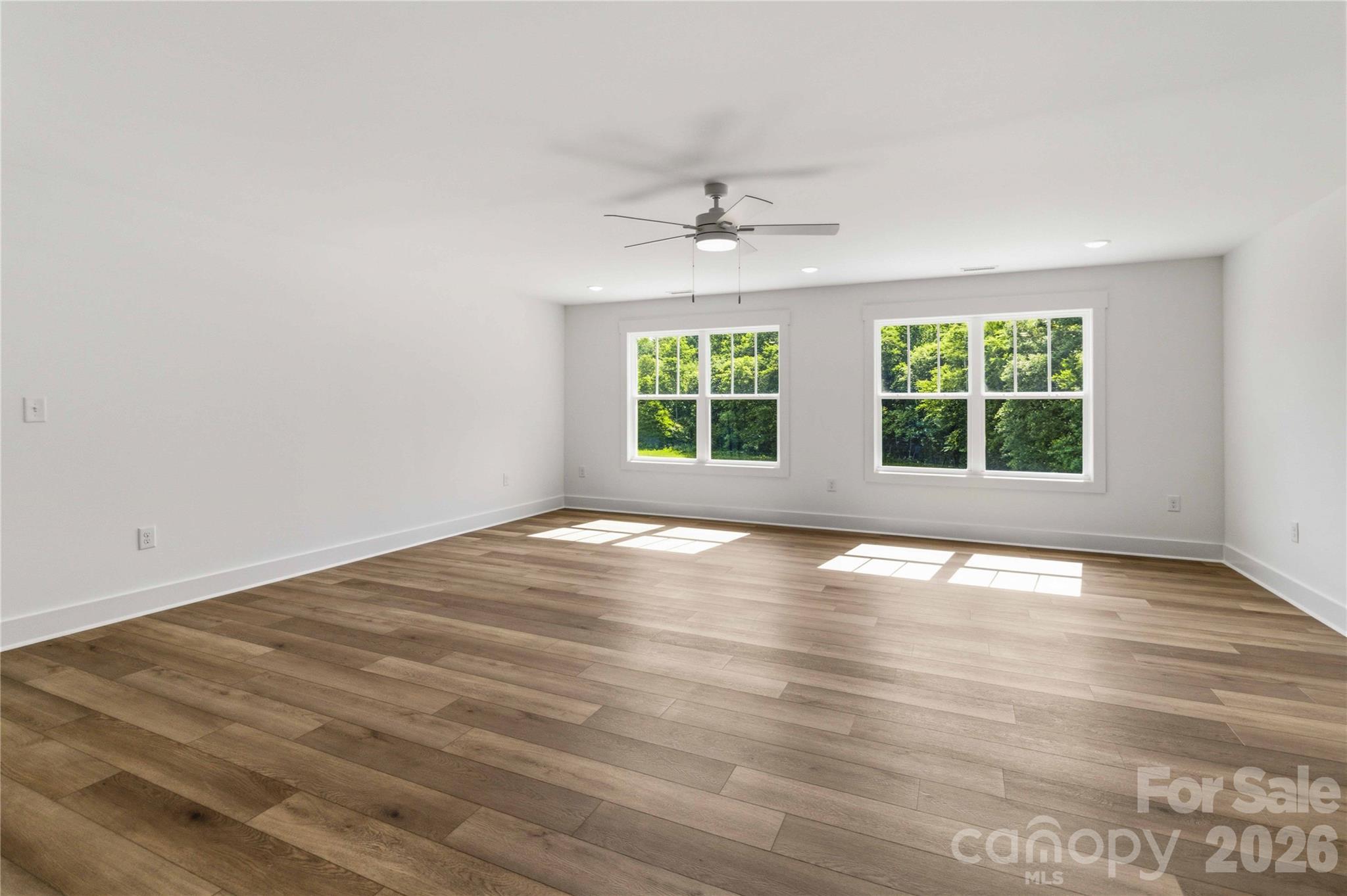 352 Adams Road Clover, SC 29710 - Photo 22 of 38 an empty room with wooden floor and windows