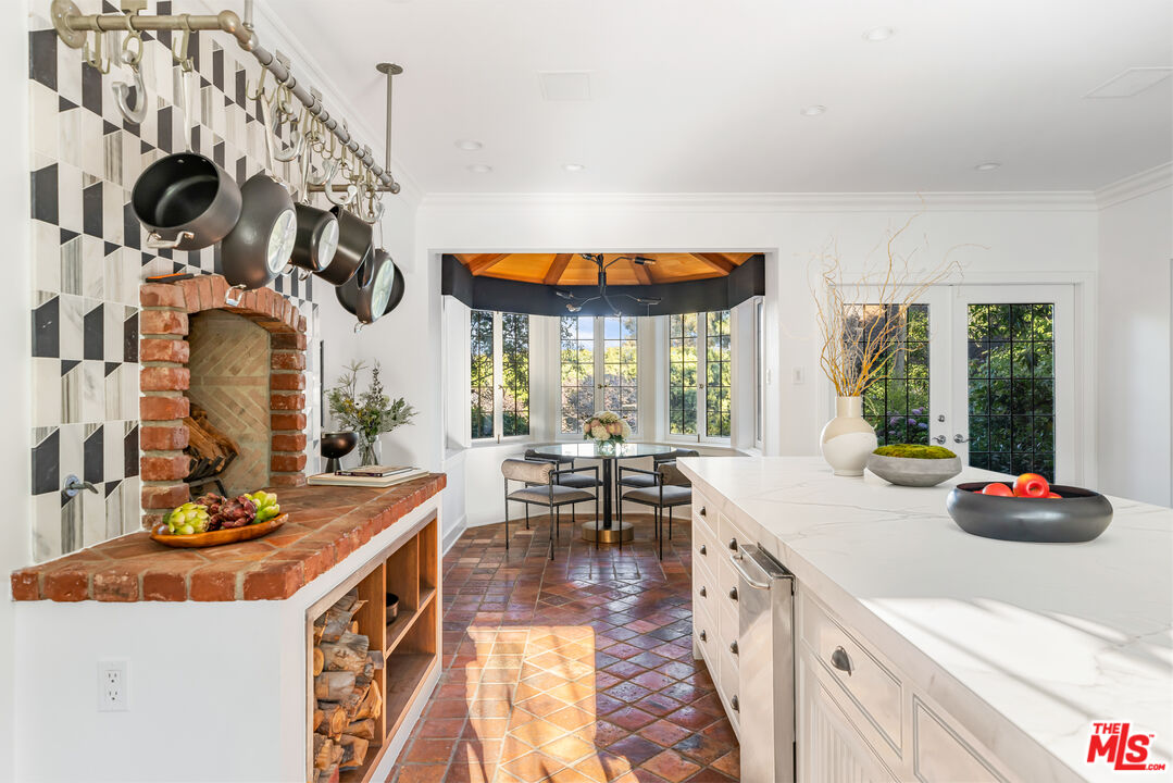 1575 Capri Drive Pacific Palisades, CA 90272 - Photo 11 of 41 a kitchen with stainless steel appliances granite countertop a sink and cabinets