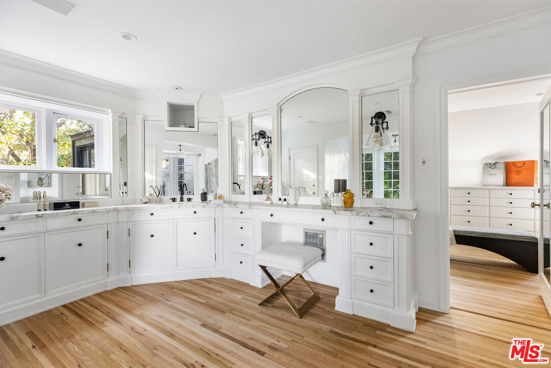 1575 Capri Drive Pacific Palisades, CA 90272 - Photo 17 of 41 a spacious bathroom with a double vanity sink a mirror a bathtub and window