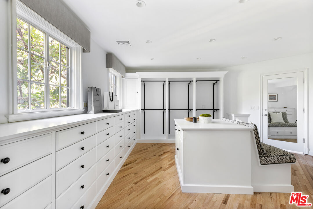 1575 Capri Drive Pacific Palisades, CA 90272 - Photo 18 of 41 a view of kitchen with stainless steel appliances kitchen island wooden floor and large window