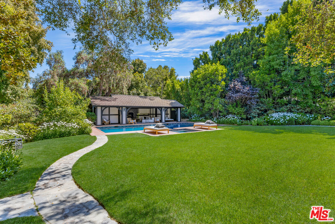 1575 Capri Drive Pacific Palisades, CA 90272 - Photo 23 of 41 a view of a swimming pool with a garden