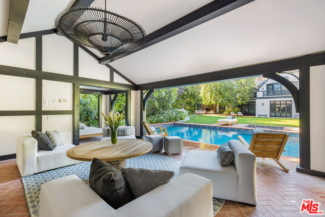 1575 Capri Drive Pacific Palisades, CA 90272 - Photo 25 of 41 a living room with furniture and a large window
