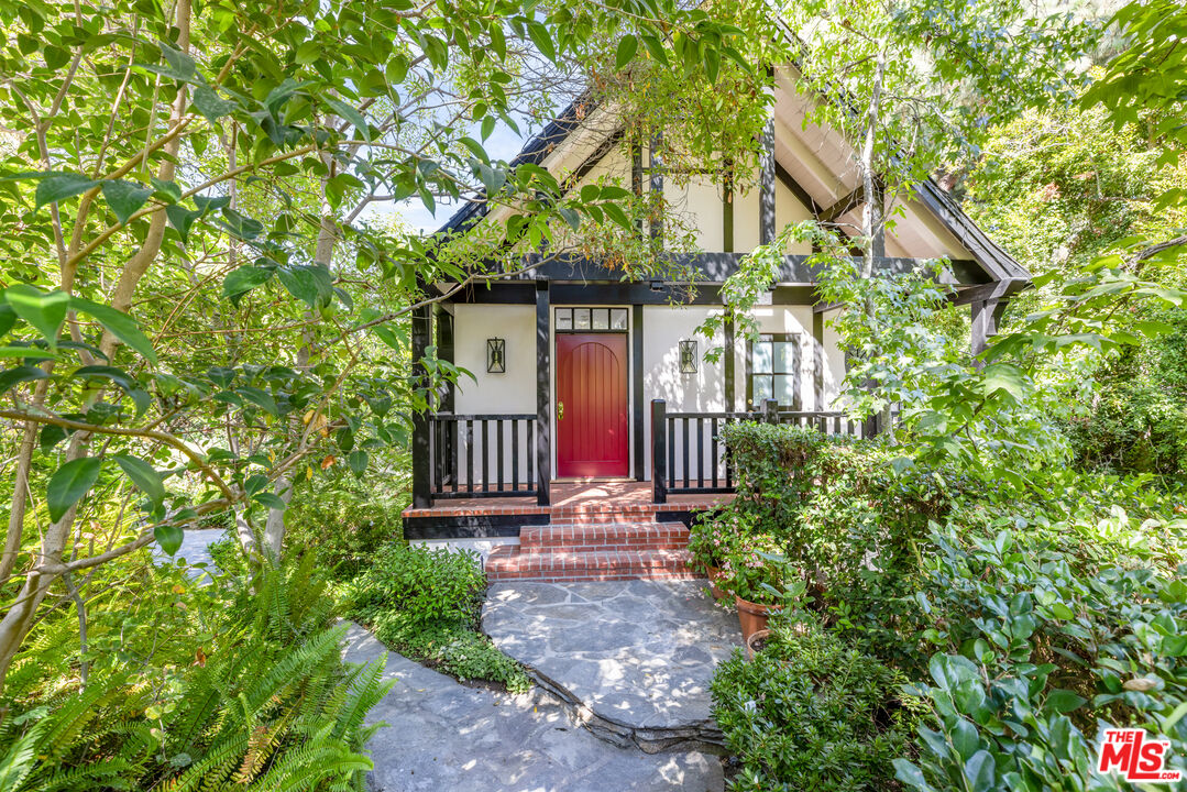 1575 Capri Drive Pacific Palisades, CA 90272 - Photo 27 of 41 a front view of a house with a yard and fountain