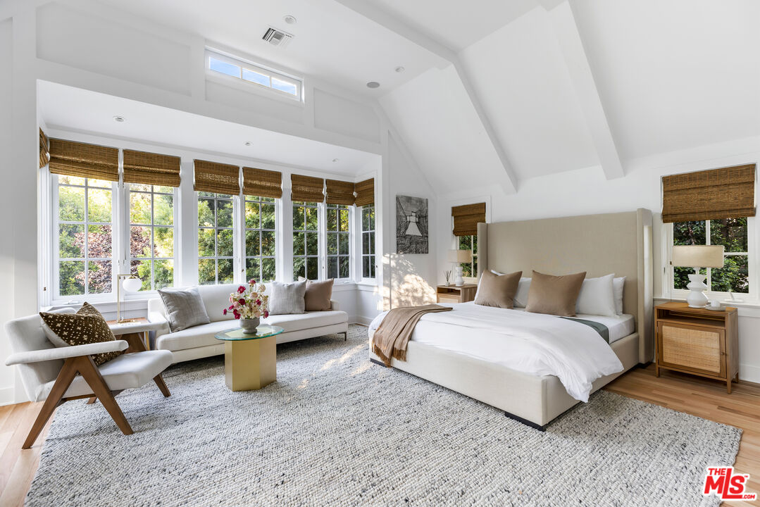 1575 Capri Drive Pacific Palisades, CA 90272 - Photo 29 of 41 a spacious bedroom with a bed and large window