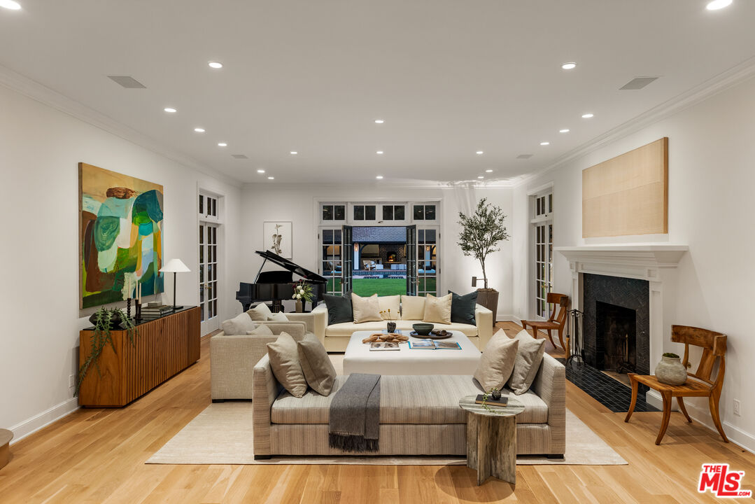 1575 Capri Drive Pacific Palisades, CA 90272 - Photo 34 of 41 a living room with fireplace furniture and a wooden floor