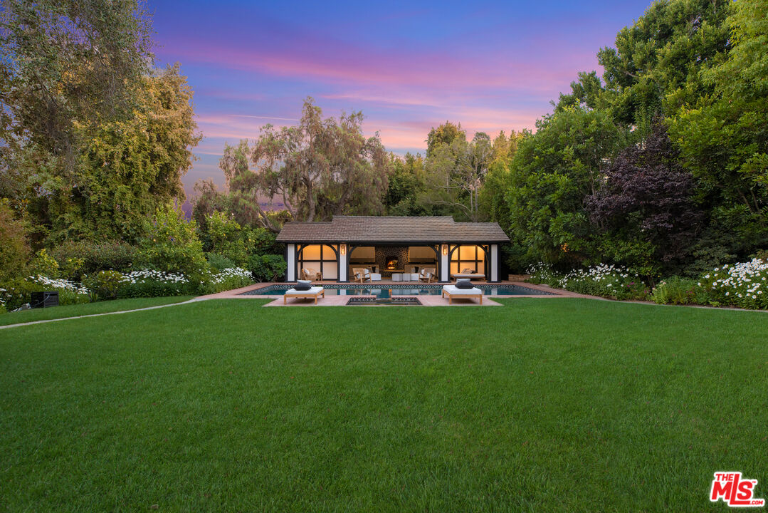 1575 Capri Drive Pacific Palisades, CA 90272 - Photo 35 of 41 a view of a house with backyard and a tree