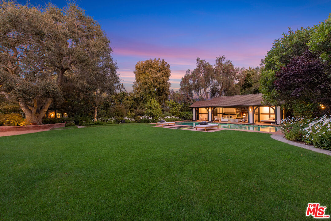 1575 Capri Drive Pacific Palisades, CA 90272 - Photo 38 of 41 a front view of a house with a yard