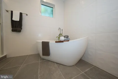 a white bath tub sitting in a bathroom