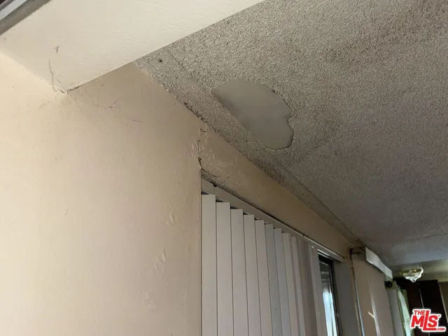 a view of staircase with white walls and white door