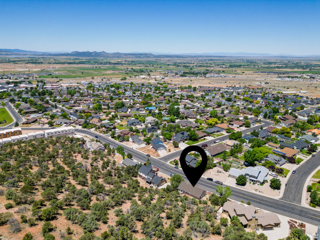 790 East Fiddlers Canyon Road Cedar City, UT 84721 - Photo 31 of 35 Aerial perspective showcasing a residential neighborhood with a mix of single-family homes and undeveloped, tree-covered land