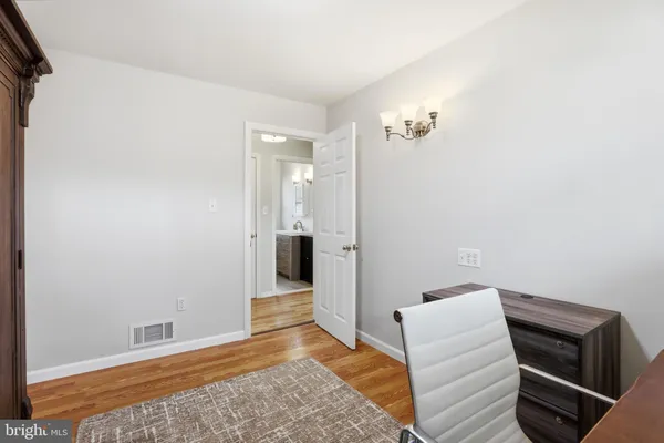 a bedroom with a bed and a television