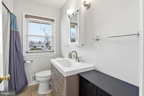 a bedroom with a bed and a ceiling fan