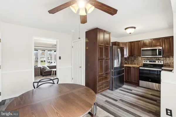 a kitchen with stainless steel appliances granite countertop a refrigerator and a stove top oven