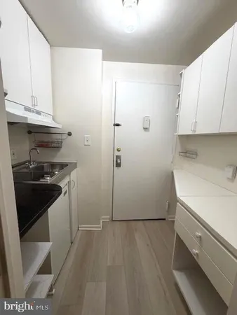 a kitchen with a sink and a stove top oven