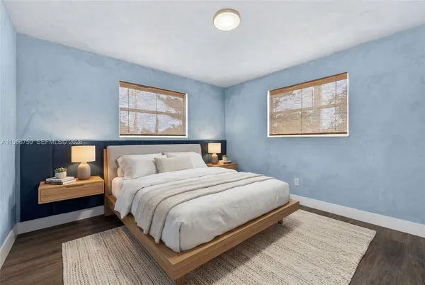 a bedroom with a bed and lamp