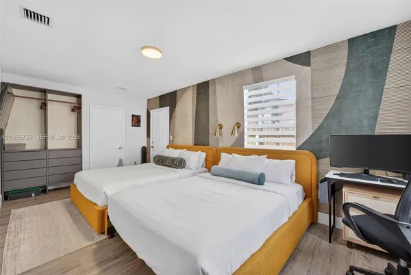 a bedroom with a bed and a desk