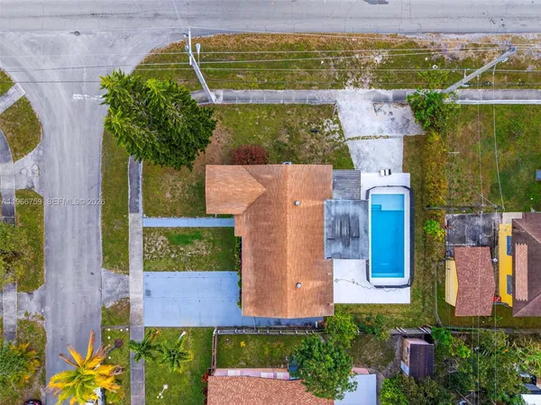 an aerial view of a house with a yard basket ball court and outdoor seating