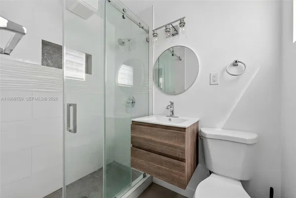 a bathroom with a toilet sink and shower