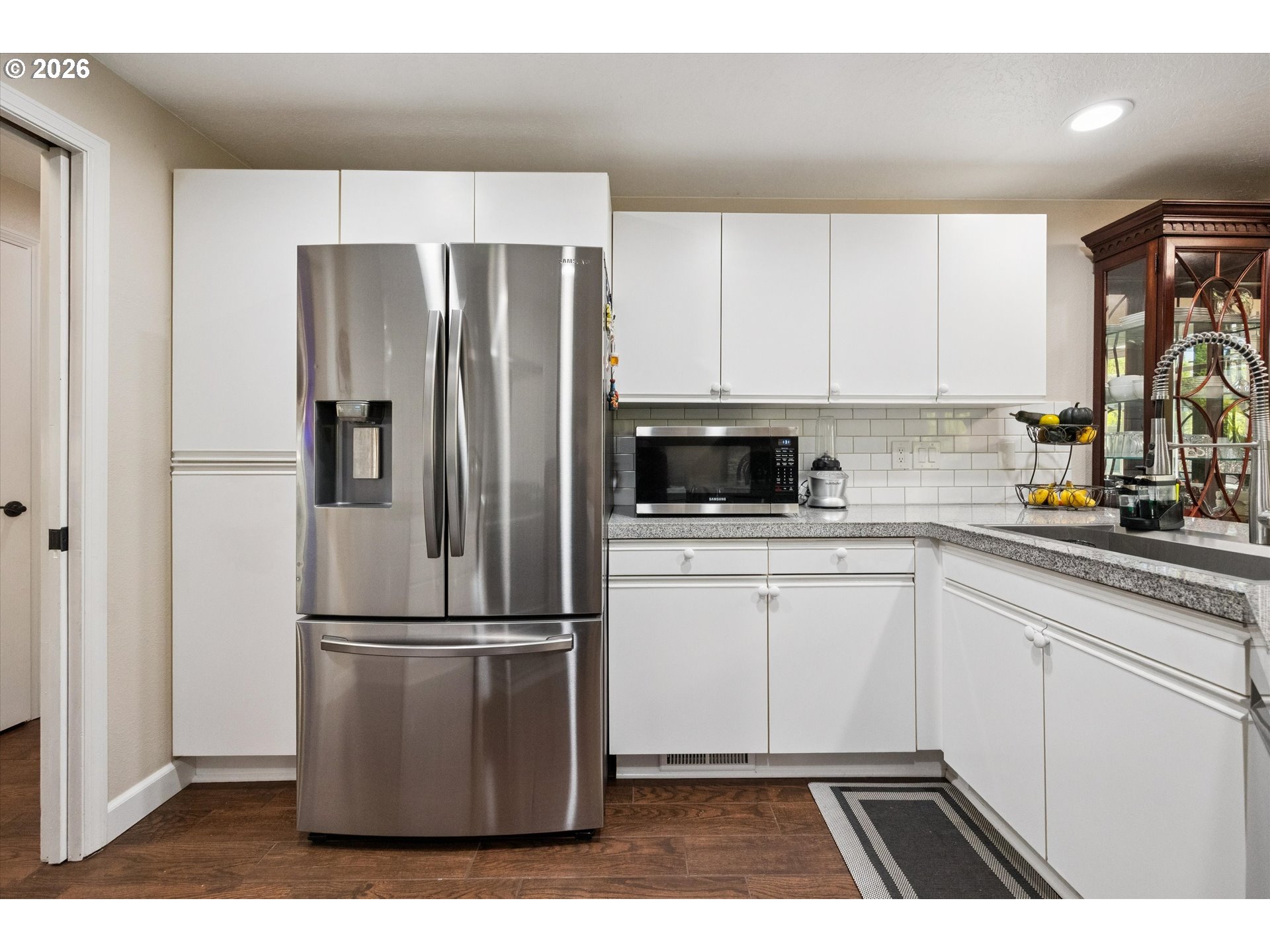 345 Southwest 207th Avenue Beaverton, OR 97006 - Photo 14 of 28 a kitchen with a refrigerator a sink and cabinets