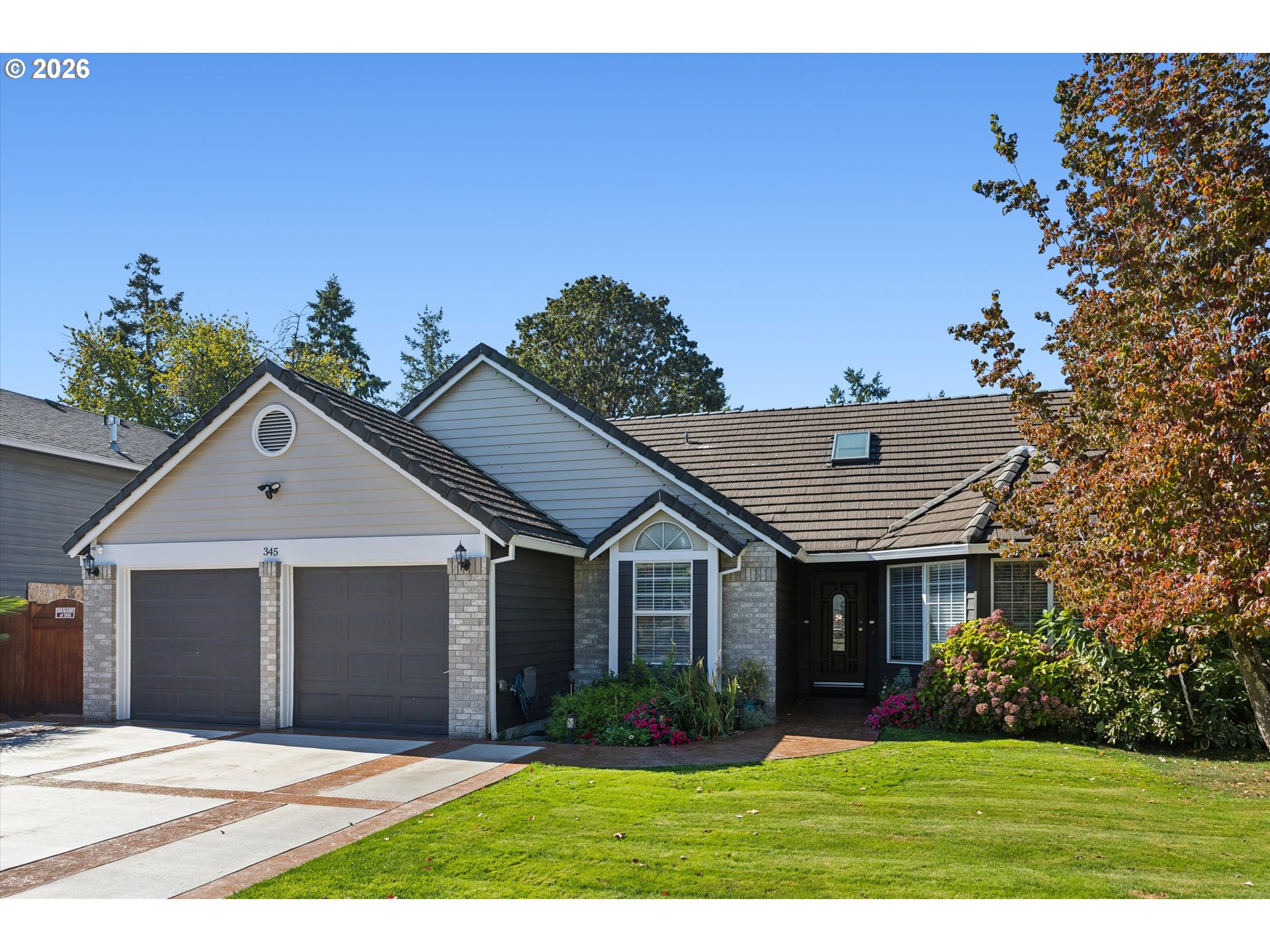 345 Southwest 207th Avenue Beaverton, OR 97006 - Photo 2 of 28 a front view of a house with a yard and garage