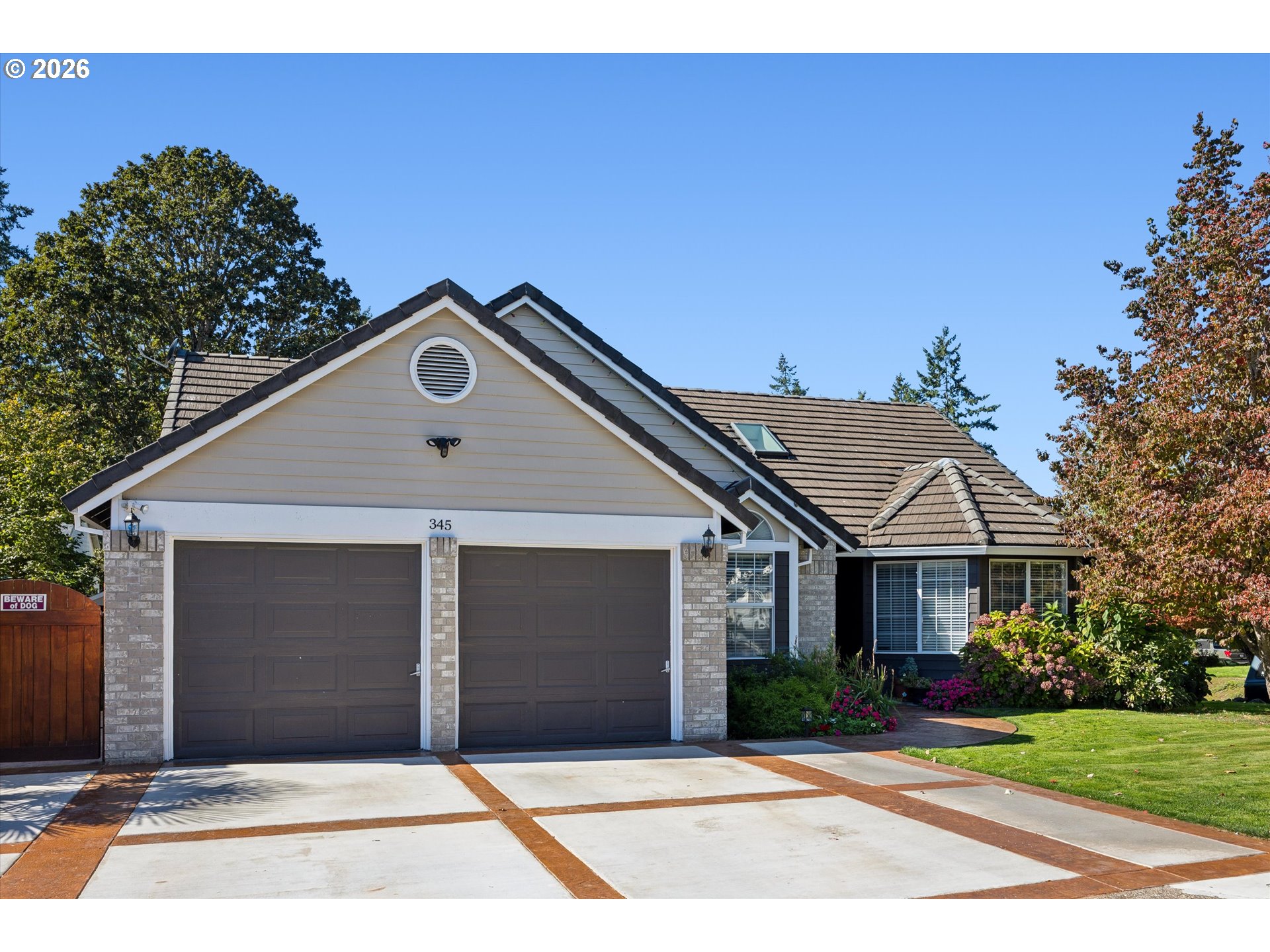 345 Southwest 207th Avenue Beaverton, OR 97006 - Photo 3 of 28 a front view of a house with a garden