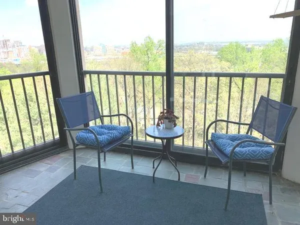 a view of a chairs and table in patio
