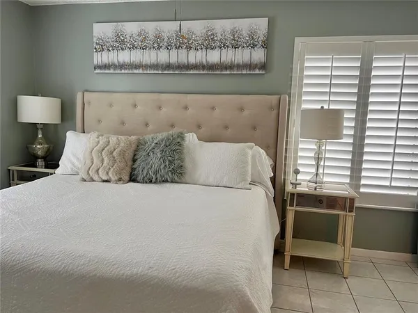 a bed sitting in a bedroom next to a window