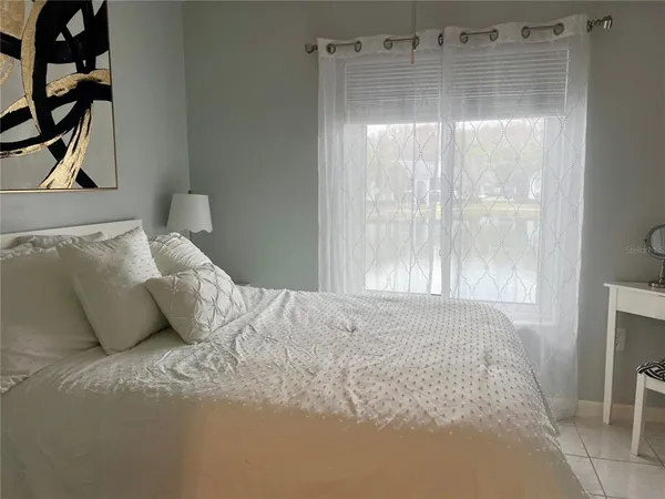a bedroom with a bed and a window