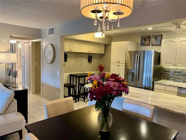 a view of a dining room with furniture a chandelier and wooden floor