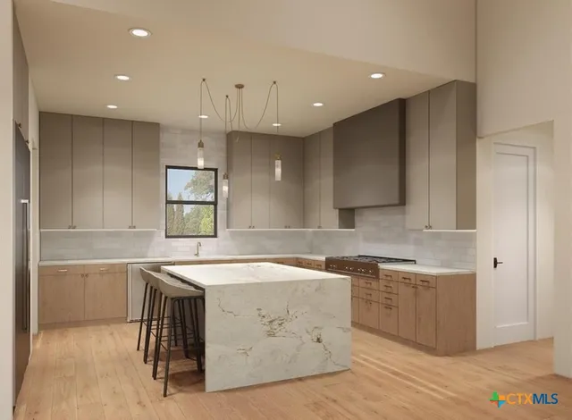 a kitchen with a sink a stove a refrigerator and cabinets