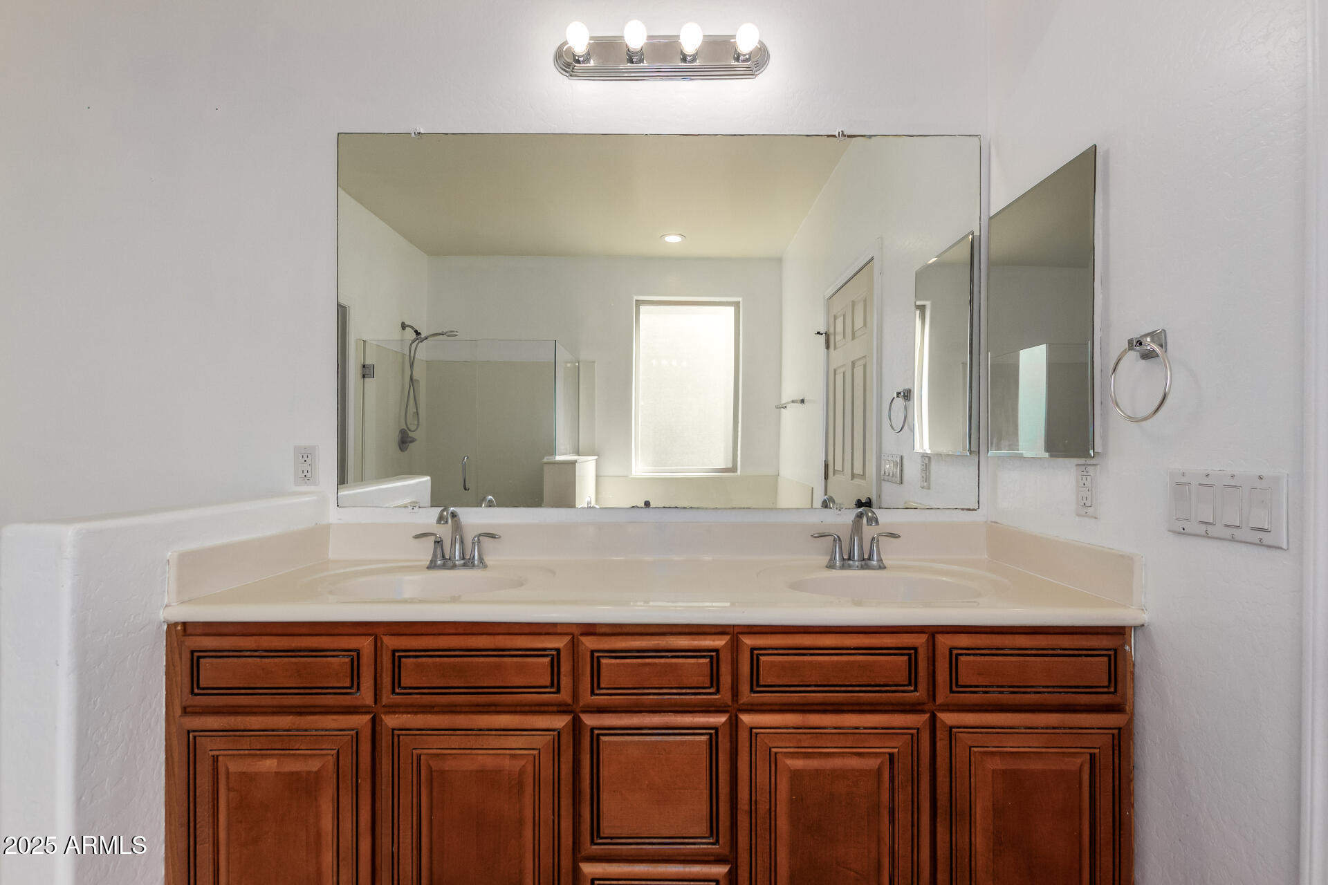 3127 West Apollo Road Phoenix, AZ 85041 - Photo 12 of 28 a bathroom with a double vanity sink and a mirror