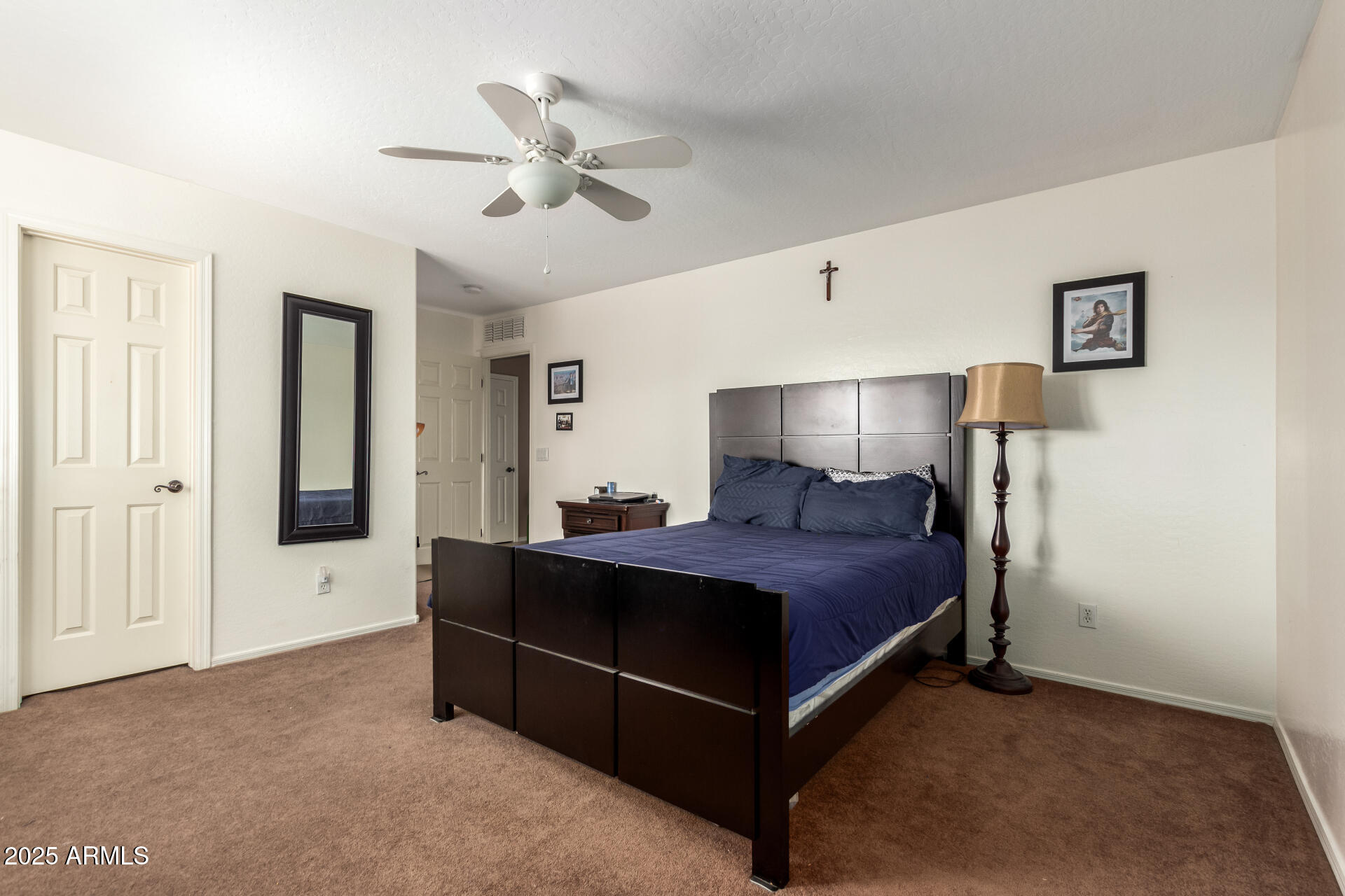 3127 West Apollo Road Phoenix, AZ 85041 - Photo 20 of 28 a bed room with a bed and a chandelier