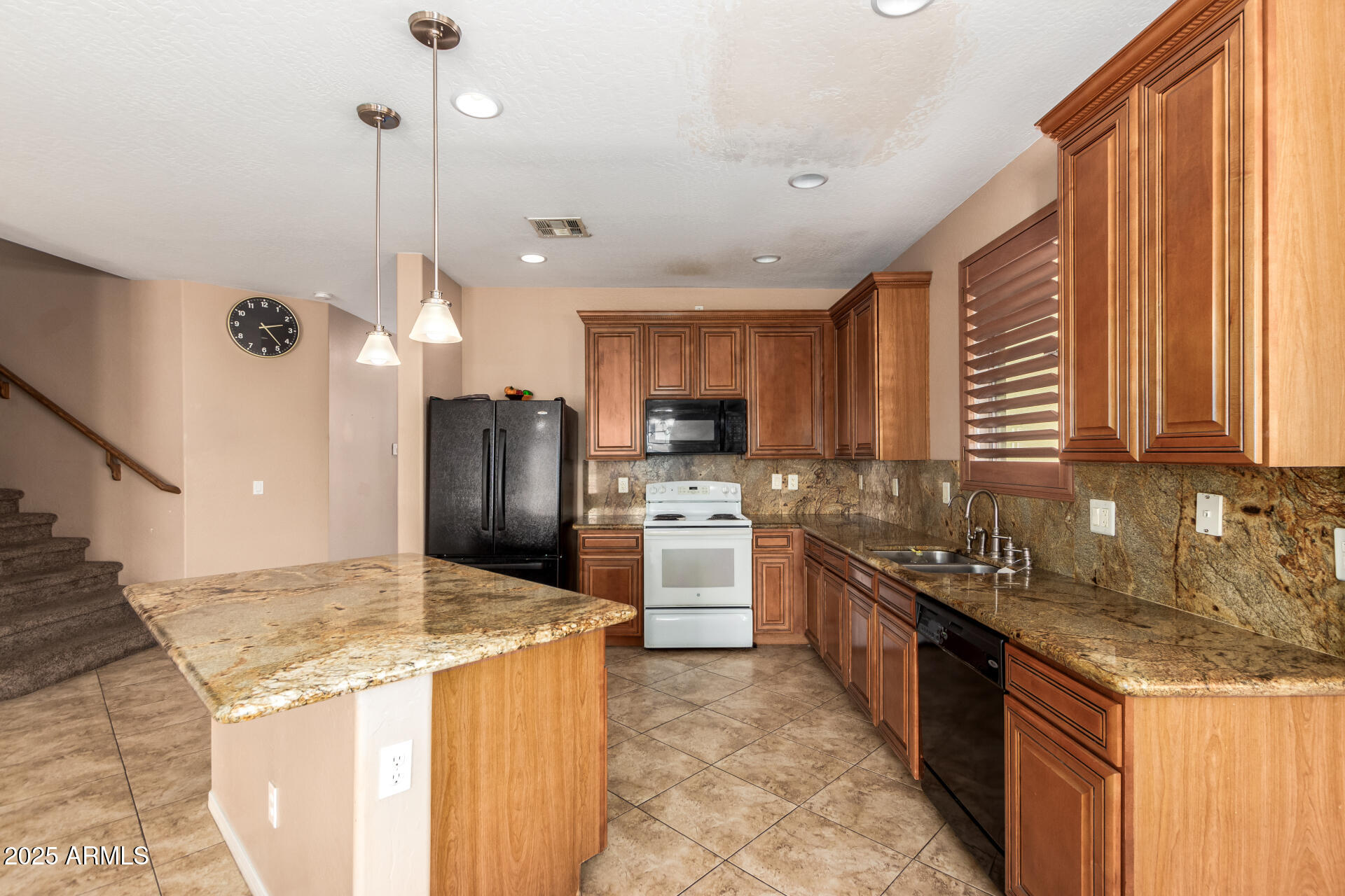 3127 West Apollo Road Phoenix, AZ 85041 - Photo 4 of 28 a kitchen with granite countertop a sink a counter top space stainless steel appliances and cabinets