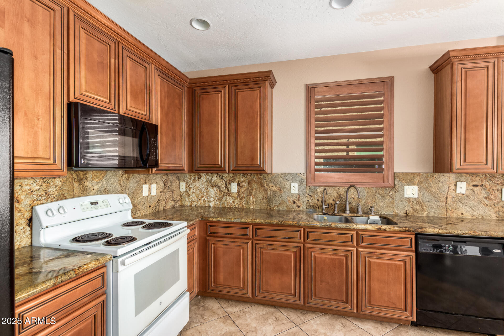 3127 West Apollo Road Phoenix, AZ 85041 - Photo 5 of 28 a kitchen with stainless steel appliances granite countertop a sink stove and microwave