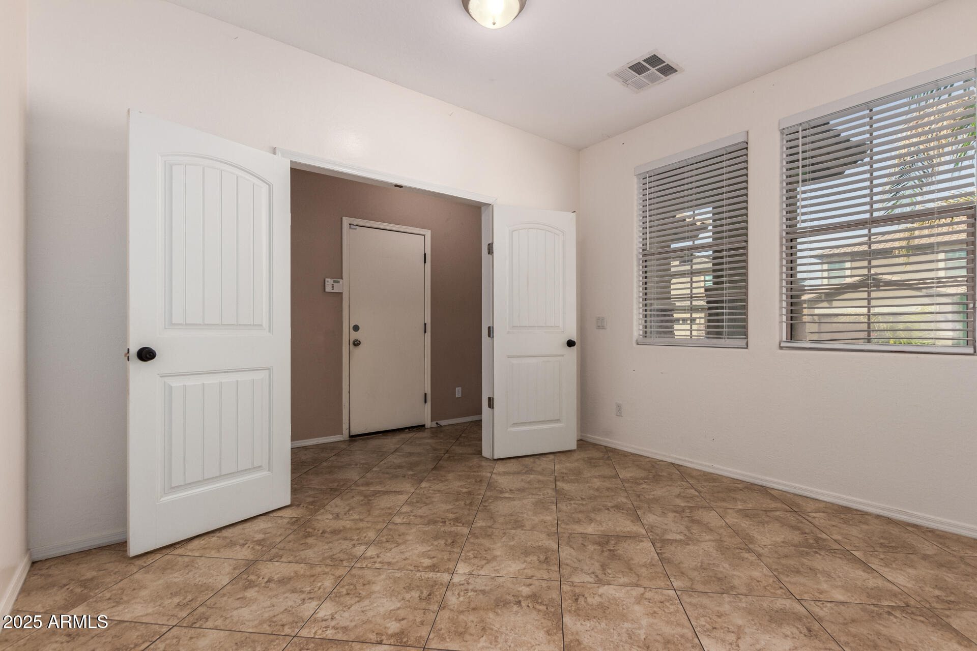 3127 West Apollo Road Phoenix, AZ 85041 - Photo 6 of 28 a view of an empty room with a window