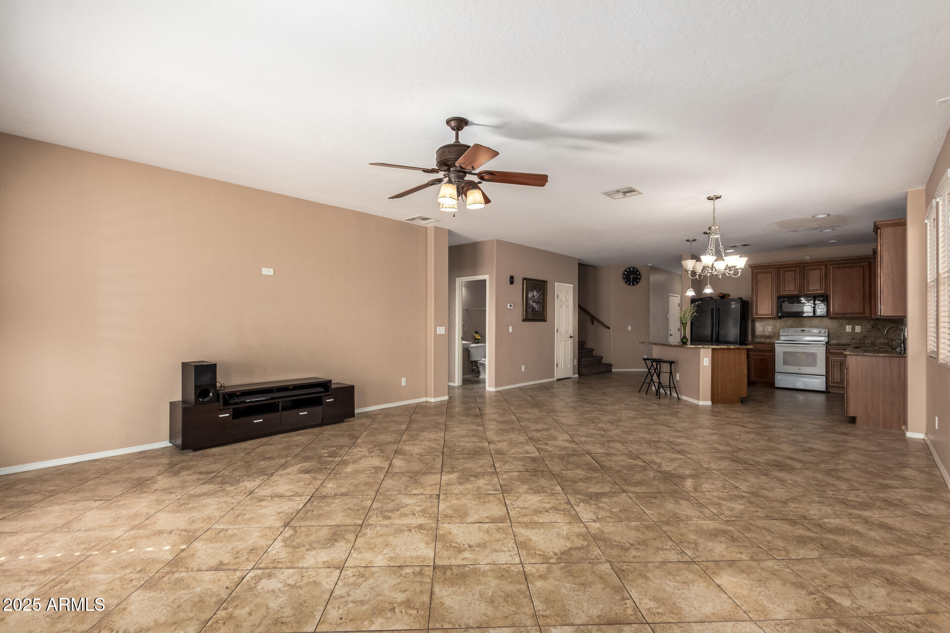 3127 West Apollo Road Phoenix, AZ 85041 - Photo 8 of 28 a living room with furniture and a chandelier