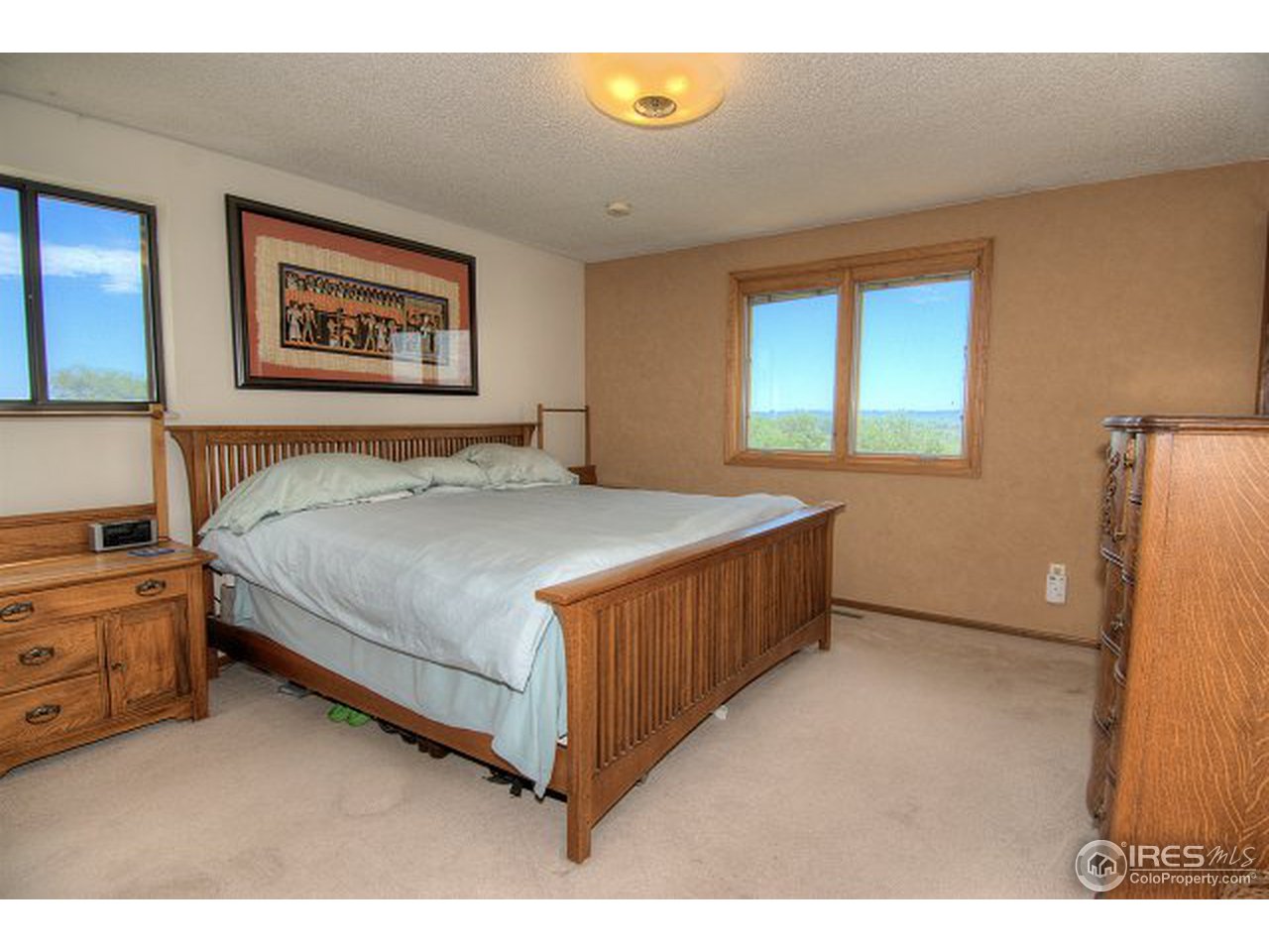 9920 Phillips Road Lafayette, CO 80026 - Photo 5 of 18 a bedroom with a bed and a dresser