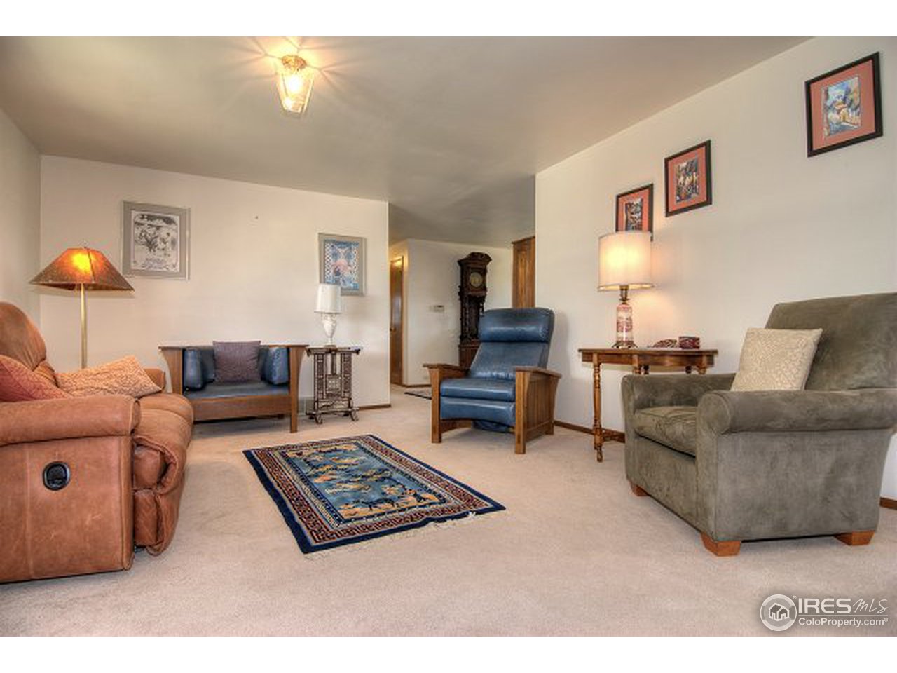 9920 Phillips Road Lafayette, CO 80026 - Photo 8 of 18 a living room with furniture a lamp and a flat screen tv