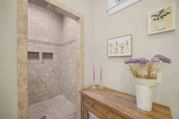 a bathroom with a granite countertop sink a toilet and shower