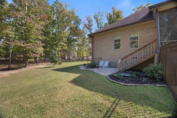 a view of a house with backyard and sitting area