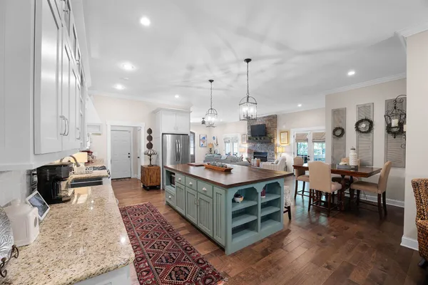 a kitchen with stainless steel appliances kitchen island granite countertop a stove and cabinets