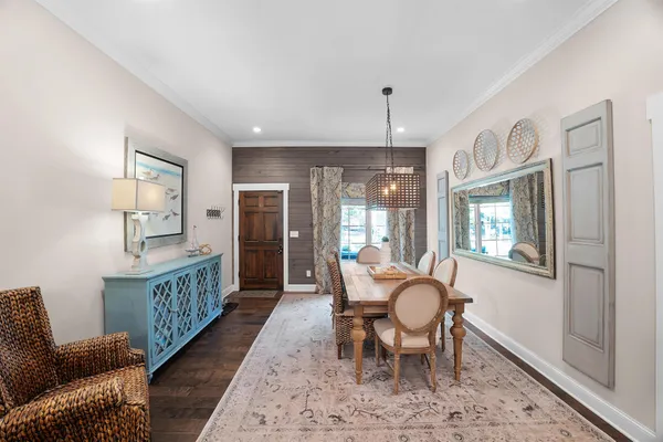 a dining room with furniture a rug and wooden floor