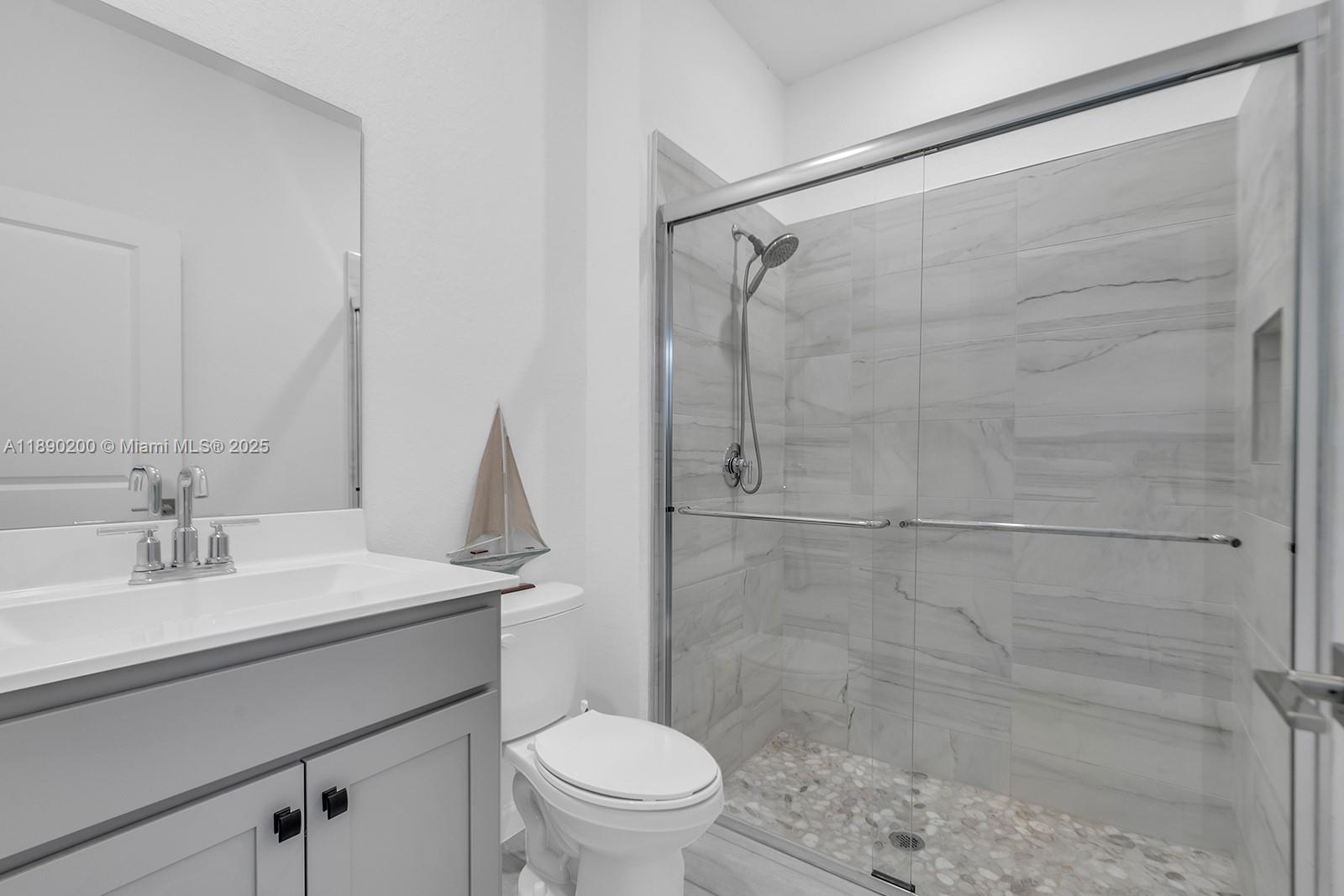 1772 Southeast 8th Street Homestead, FL 33033 - Photo 13 of 42 a bathroom with a sink toilet and shower