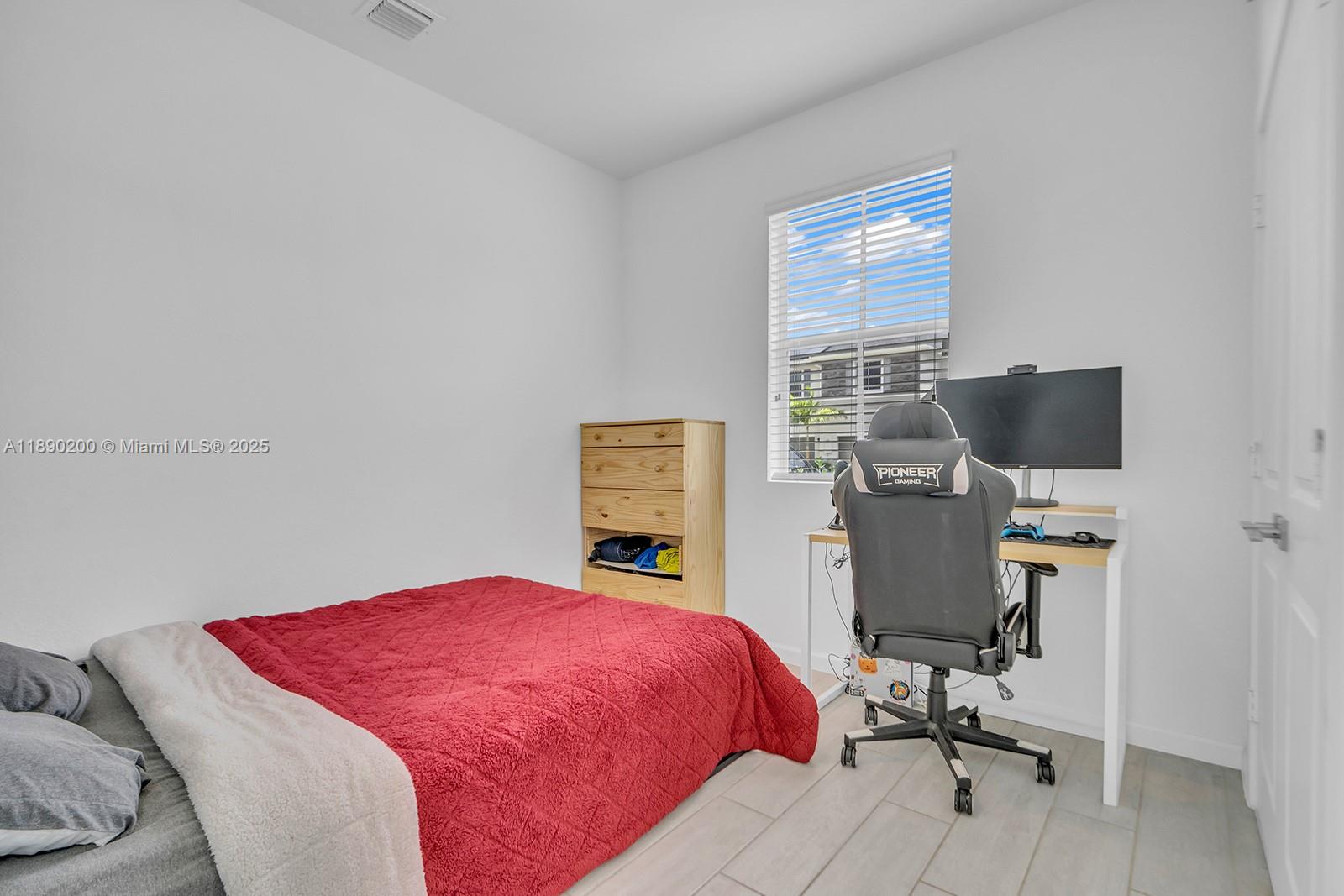 1772 Southeast 8th Street Homestead, FL 33033 - Photo 14 of 42 a bedroom with a bed and a desk