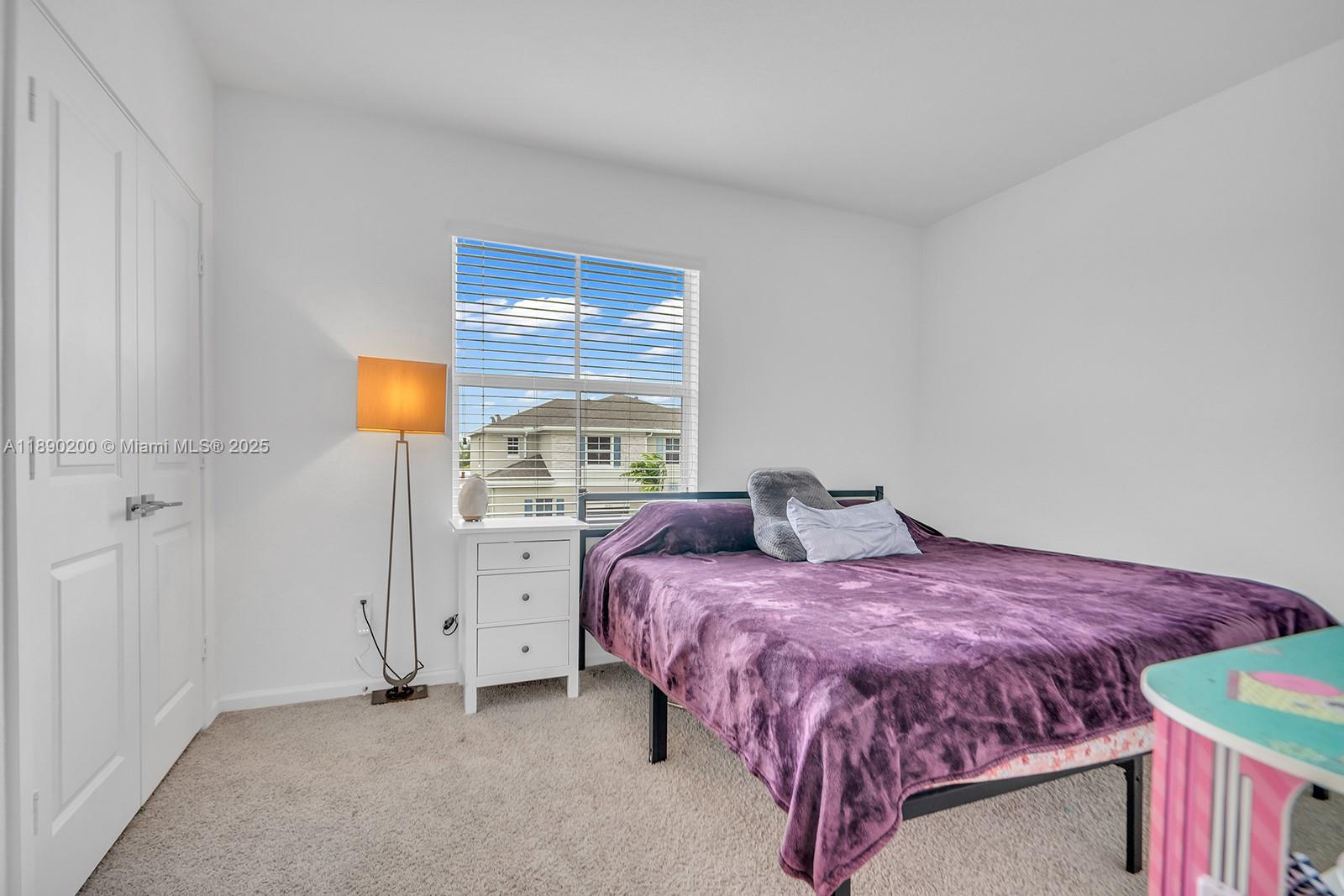 1772 Southeast 8th Street Homestead, FL 33033 - Photo 19 of 42 a bedroom with a bed and a window