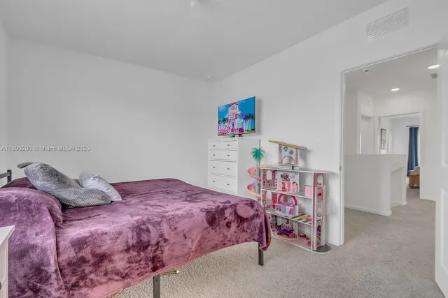 a bedroom with a bed and a book shelf
